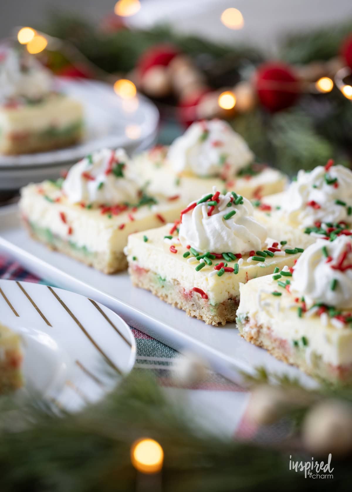 festive table with a platter of sugar cookie cheesecake bars.