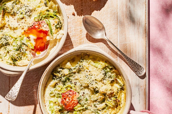 Two bowls of eggs en cocotte in the sunshine