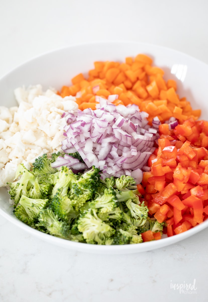 making veggie pizza dip in a bowl