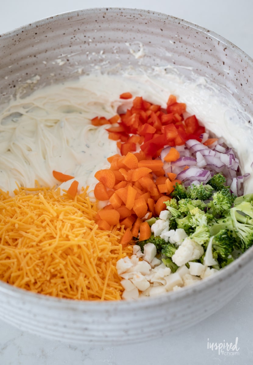 making veggie pizza dip in a bowl