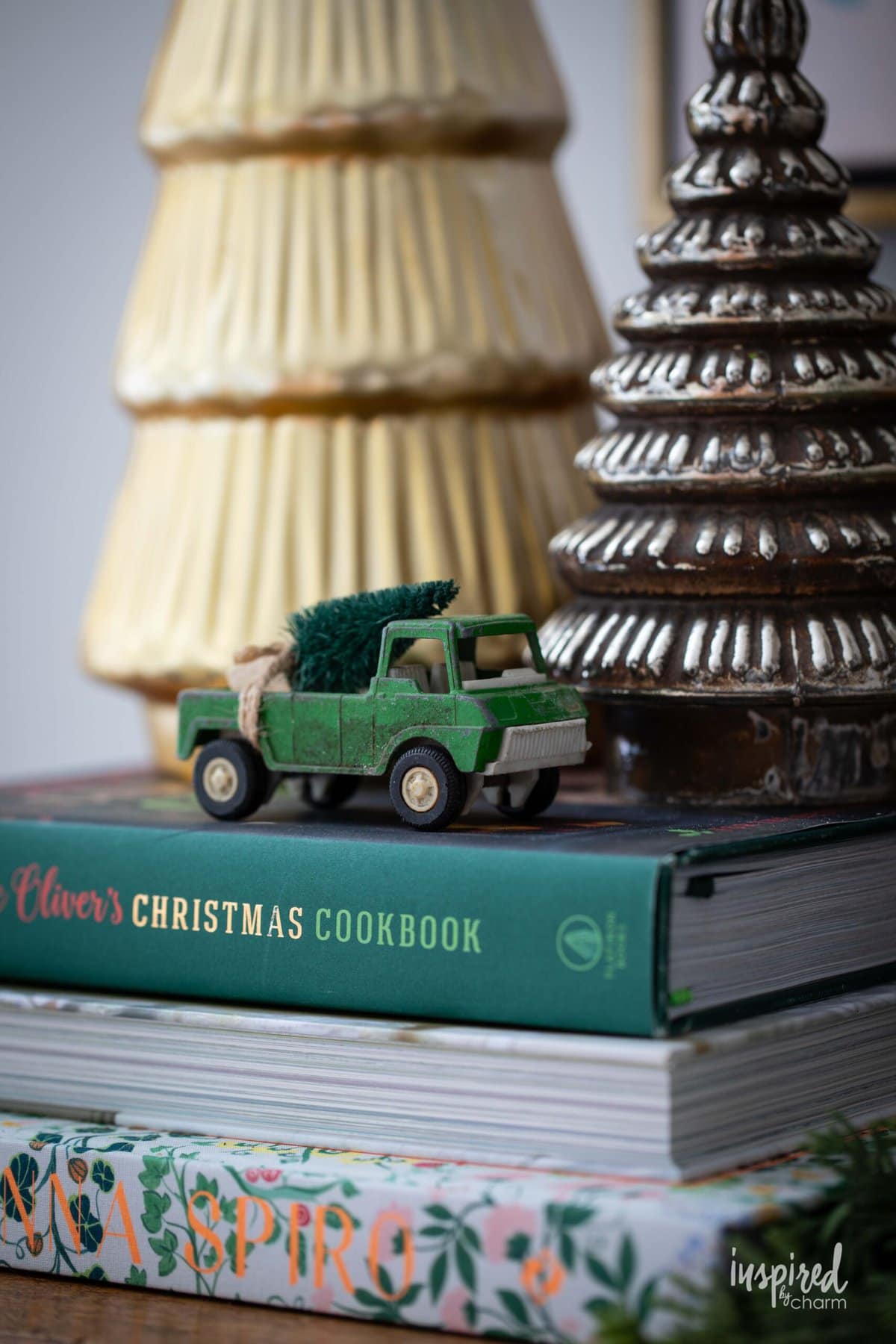 small vintage toy truck with wreath on back.