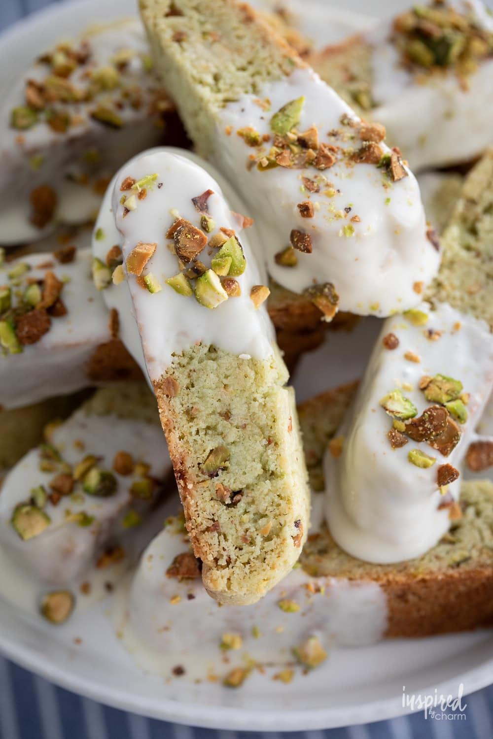 white chocolate pistachio biscotti on a plate.
